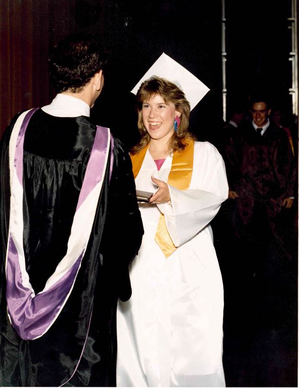 Ms. With receiving her diploma